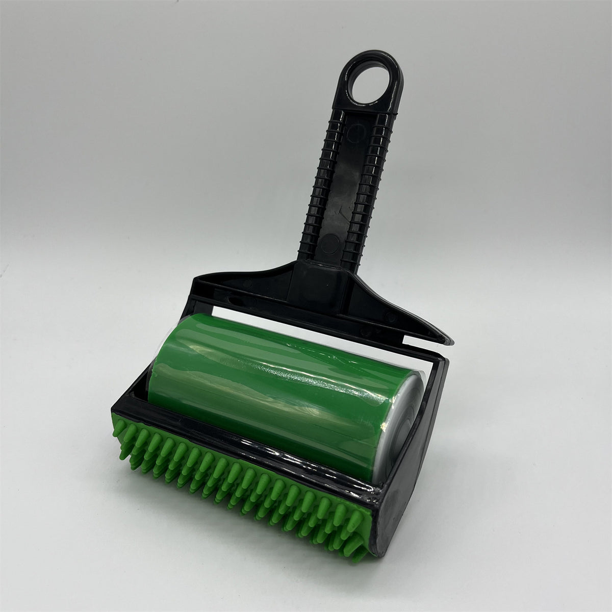 Pet hair remover roller removing dog fur from upholstery, close-up